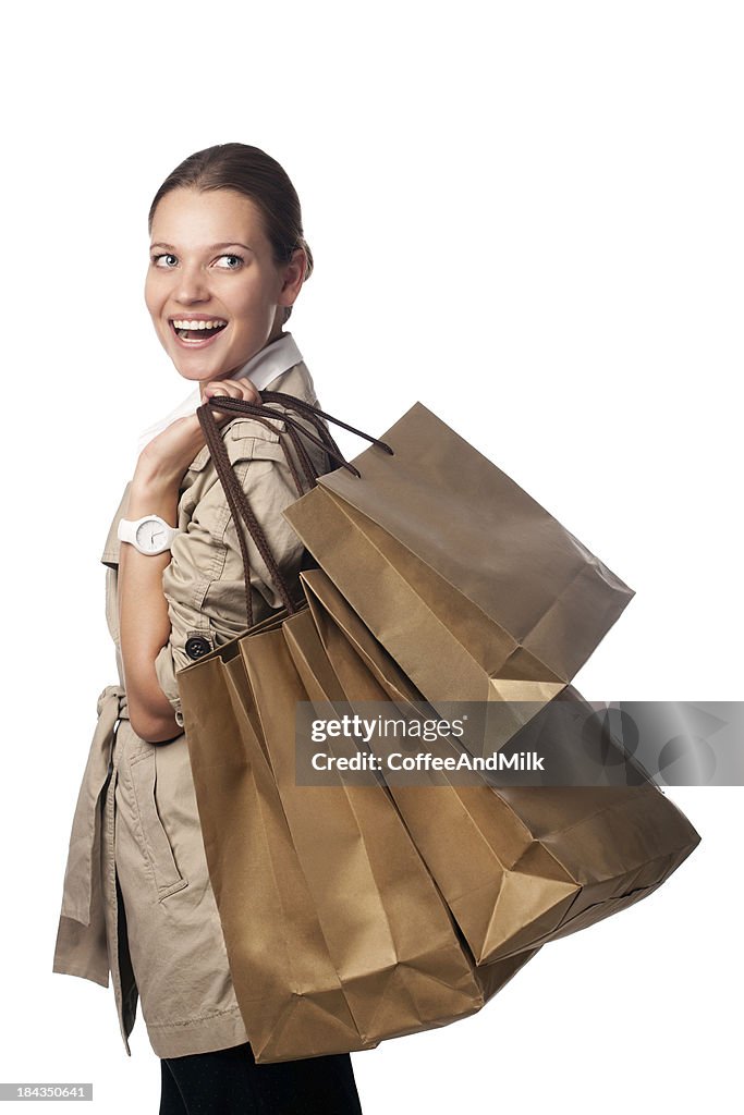 Beautiful woman holding bags on white background