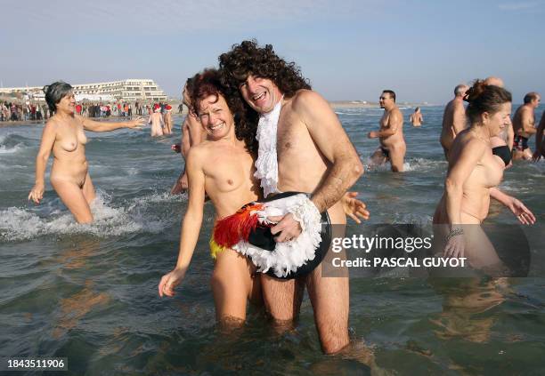 Man with 16th century style hat and outfit enjoys a Mediterranean cold bath with his companion as water temperature reaches 8°C in Cap 'Adge,...