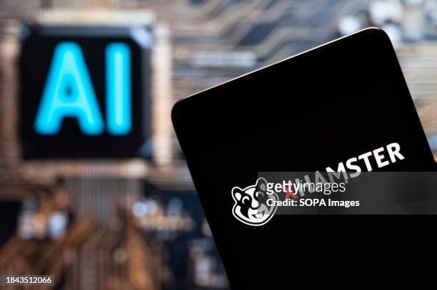 In this photo illustration, the adult pornographic video-sharing site Xhamster logo seen displayed on a smartphone with an Artificial intelligence...