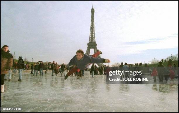 Man leaps on his ice skates 29 December on the ice covering the Trocadéro lake in Paris. France had it's coldest night of the year between 28-29...