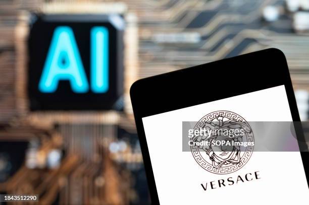 In this photo illustration, the Italian luxury fashion company Versace logo seen displayed on a smartphone with an Artificial intelligence chip and...