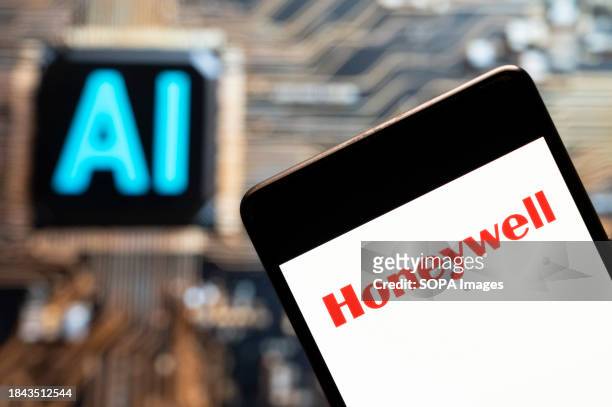 In this photo illustration, the American Aerospace manufacturer of aircraft engines and avionics, Honeywell logo seen displayed on a smartphone with...
