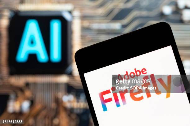 In this photo illustration, the Adobe Firefly logo seen displayed on a smartphone with an Artificial intelligence chip and symbol in the background.