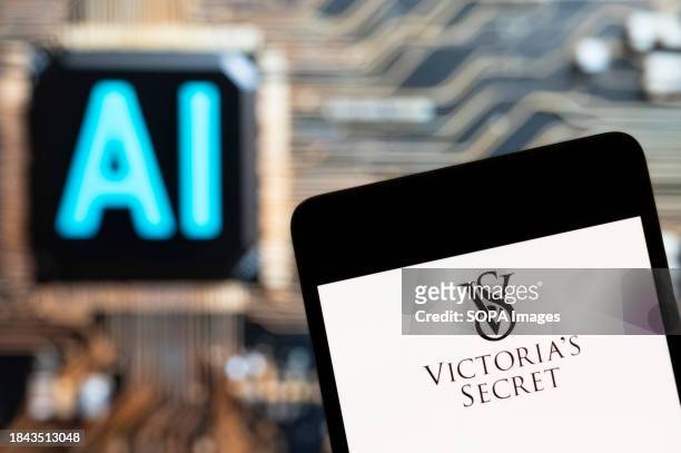 In this photo illustration, the American lingerie, womenswear, and beauty products brand, Victoria's Secret, logo seen displayed on a smartphone with...