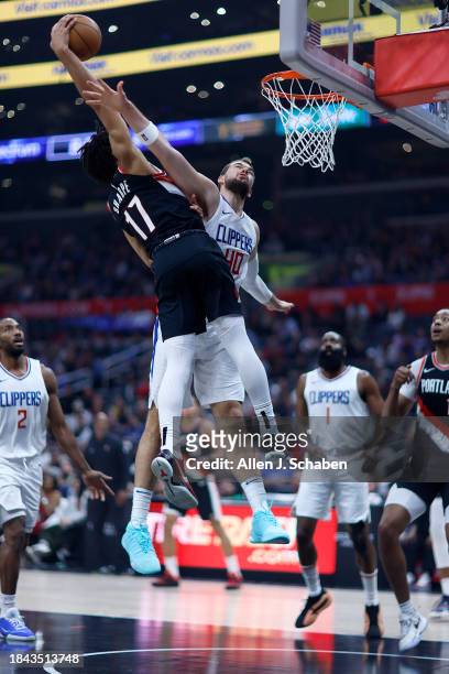 Los Angeles, CA LA Clippers center Ivica Zubac, #40, right, fouls Portland Trail Blazers guard Sharron Sharpe, #17 as he goes up for a missed dunk in...