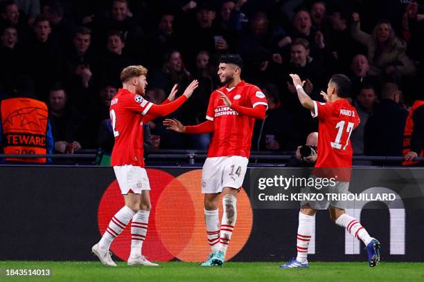 Eindhoven's Belgian forward Yorbe Vertessen celebrates with PSV Eindhoven's US forward Ricardo Pepi and PSV Eindhoven's Brazilian defender Mauro...