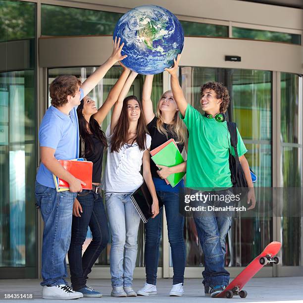 teenager lifting the world - world children day stock pictures, royalty-free photos & images