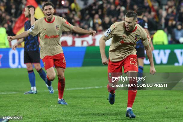 Lens' Polish defender Przemyslaw Frankowski celebrates after scoring his team's first goal during the Champions League football match between RC Lens...