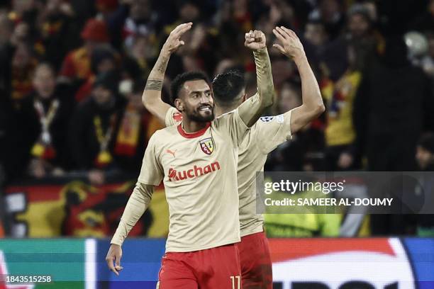 Lens' French midfielder Angelo Fulgini celebrates with teammatesafter his team won the Champions League football match between RC Lens and Sevilla at...