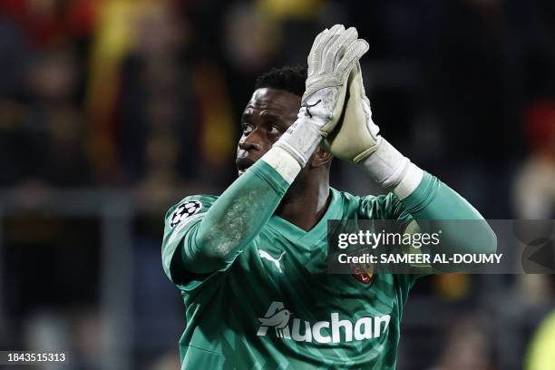 Lens' playesr and Lens' Franco-Congolese goalkeeper Brice Samba celebrate after his team won the Champions League football match between RC Lens and...