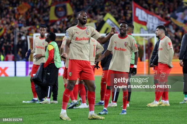 Lens' players celebrate after winning the Champions League football match between RC Lens and Sevilla at the Stade Bollaert-Delelis in Lens, northern...