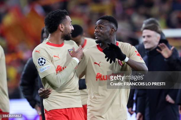 Lens' French midfielder Angelo Fulgini and Lens' Ghanaian midfielder Salis Abdul Samed celebrate after winning the Champions League football match...