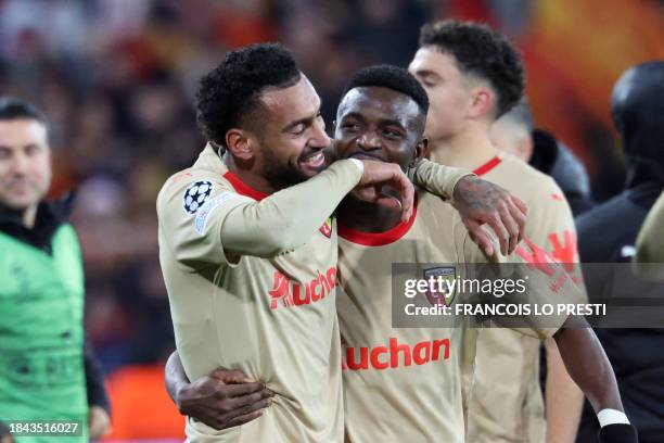 Lens' French midfielder Angelo Fulgini and Lens' Ghanaian midfielder Salis Abdul Samed celebrate after winning the Champions League football match...