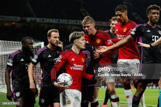 Tempers flare between Alejandro Garnacho of Manchester United and Harry Kane of Bayern Munich during the UEFA Champions League match between...