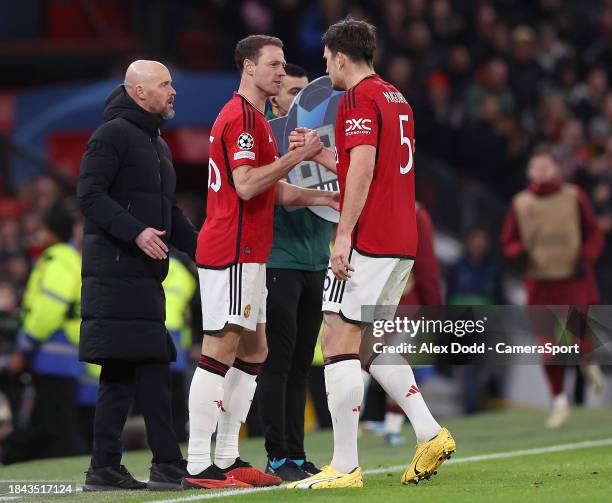 Manchester United's Harry Maguire is replaced by Jonny Evans after pulling up with an injury during the UEFA Champions League match between...