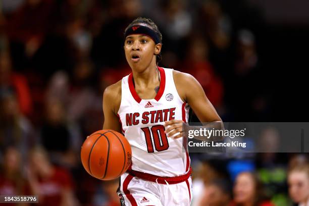 Aziaha James of the NC State Wolfpack dribbles up court during their game against the Liberty Lady Flames at Reynolds Coliseum on December 10, 2023...