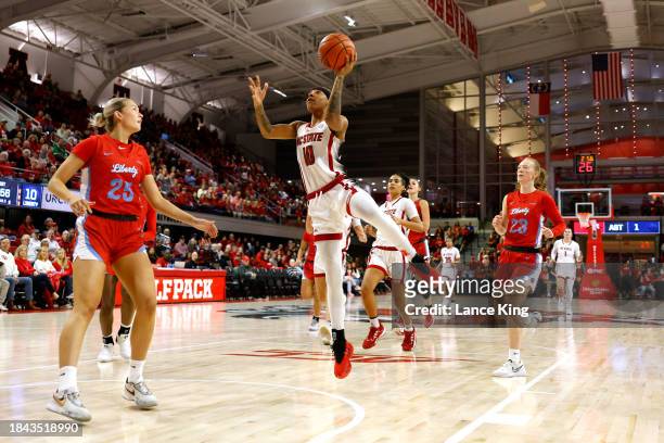 Aziaha James of the NC State Wolfpack goes to the basket against Elisabeth Aegisdottir of the Liberty Lady Flames at Reynolds Coliseum on December...