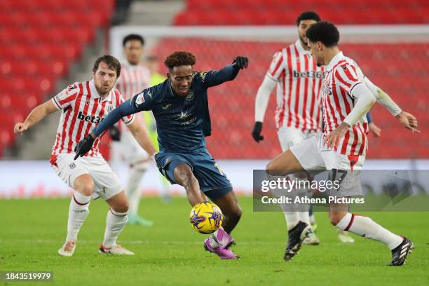 Jamal Lowe of Swansea City avoids Ben Pearson of Stoke City during the Sky Bet Championship match between Stoke City and Swansea City at the bet365...