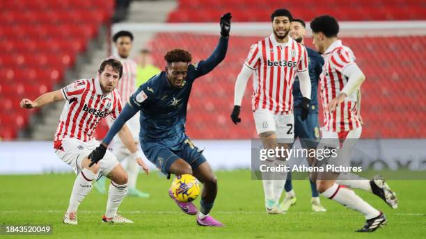 Jamal Lowe of Swansea City avoids Ben Pearson of Stoke City during the Sky Bet Championship match between Stoke City and Swansea City at the bet365...