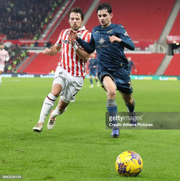 Ben Pearson of Stoke City challenges Charlie Patino of Swansea City during the Sky Bet Championship match between Stoke City and Swansea City at the...
