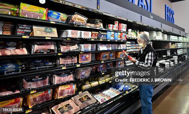 Consumers shop for groceries at a retail chain store in Rosemead, California, on December 12, 2023. US inflation slowed to a 3.1 percent annual rate...