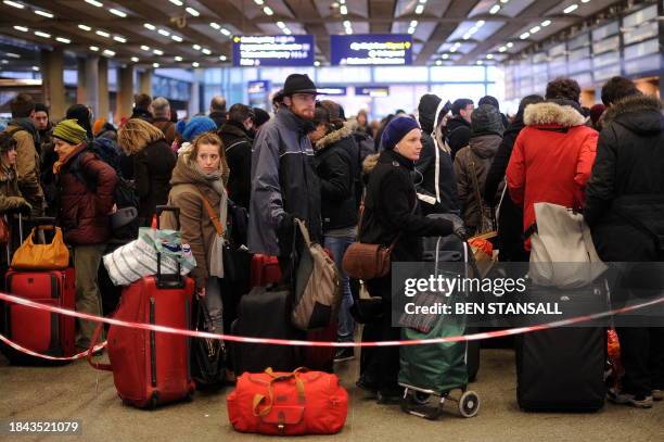 Passengers queue at the Eurostar train terminal, at St Pancras International station in London, on December 21, 2010. Thousands of angry travellers...