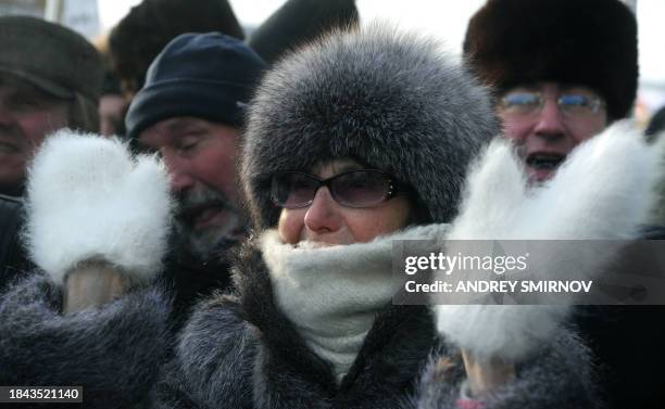 Demonstrators brave the cold while taking part in a anti-Putin rally in central Moscow, on February 4 to urge Putin to quit power ahead of March 4...