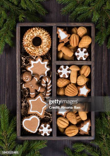 christmas. new year. cookies in a wooden box. gingerbread cookies with sugar icing. in the shape of a star, a christmas tree, a snowflake, a gingerbread man with a cane, a heart. cookies in the shape of a nut, mushroom, cone. ring cookies with peanuts. - rustic star stock pictures, royalty-free photos & images