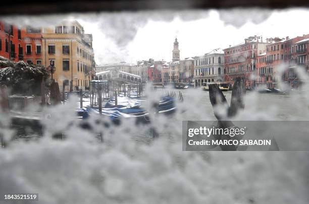 This picture taken from a window of a Vaporetto boat-taxi shows Ponte di Rialto covered with snow on March 10, 2010. The weather worsen in Italy on...