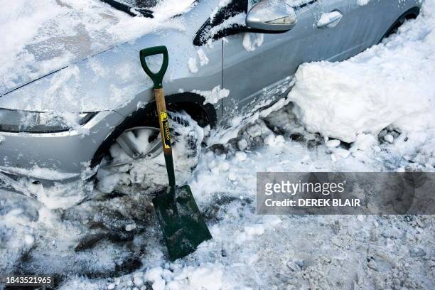 Shovel is pictured beside a car in Denholm in Scotland, on January 7, 2010. Eurostar passengers faced new winter misery when another high-speed train...