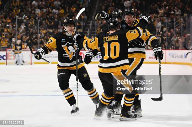 Jeff Carter of the Pittsburgh Penguins celebrates with teammates after scoring a short-handed goal in the first period during the game against the...