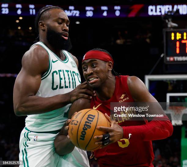 Caris LeVert of the Cleveland Cavaliers tries to get past Jaylen Brown of the Boston Celtics during the second half at TD Garden on December 12, 2023...