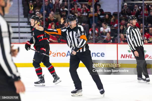Referee Garrett Rank points for a penalty shot during third period National Hockey League action between the Carolina Hurricanes and Ottawa Senators...