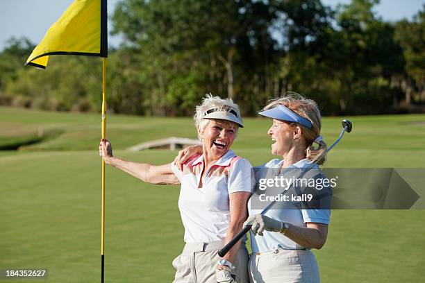 senior women playing golf. - golf player stockfoto's en -beelden