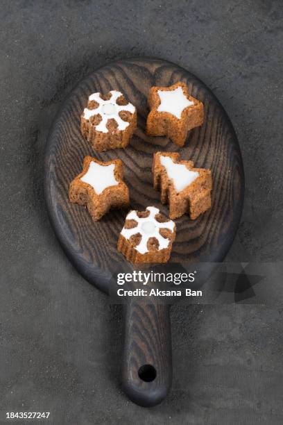 holiday cookies in the shape of a christmas tree, stars and snowflakes, with white marmalade filling. on a wooden board. dark background. top view. nrw year. christmas - rustic star stock pictures, royalty-free photos & images