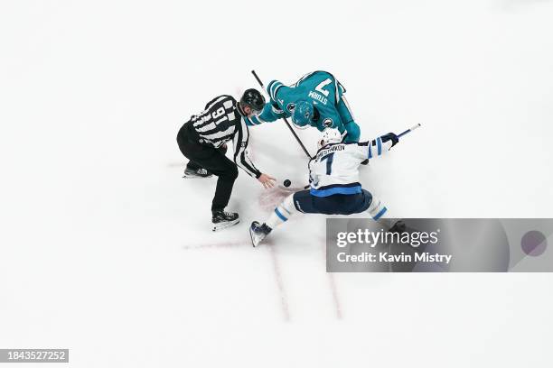 An overhead view as Nico Sturm of the San Jose Sharks takes a face-off against Vladislav Namestnikov of the Winnipeg Jets at SAP Center on December...