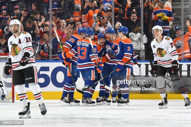 Zach Hyman of the Edmonton Oilers celebrates after his third period goal against the Chicago Blackhawks with teammates Connor McDavid, Evan Bouchard,...