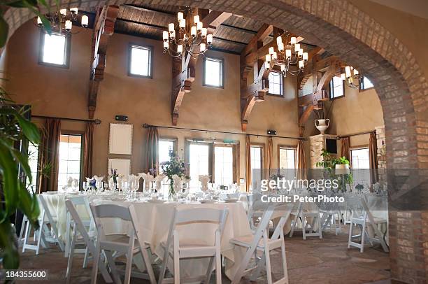 spanish style restaurant with white chairs and tables - wedding reception stock pictures, royalty-free photos & images