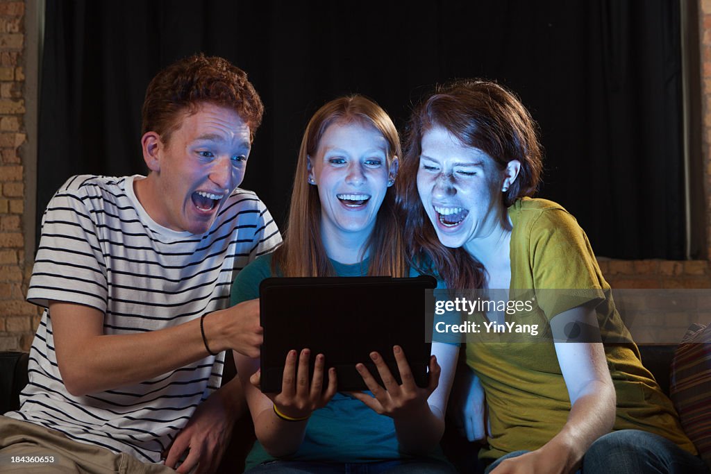 Young Adults Watching Movie on Tablet Computer, Friends Laughing Together