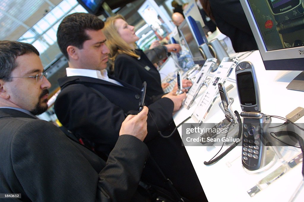 Computer Trade Visitors check out mobile phones with integrated gaming options from ...