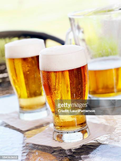 pints of beer on an outdoor patio - beer summer bildbanksfoton och bilder