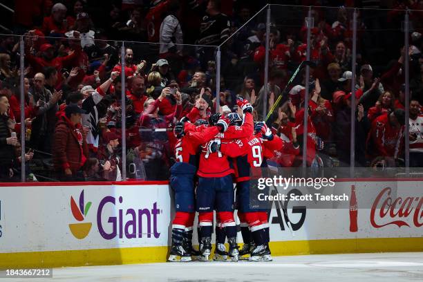 Sonny Milano of the Washington Capitals celebrates with John Carlson, Evgeny Kuznetsov and teammates after scoring a goal against the New York...