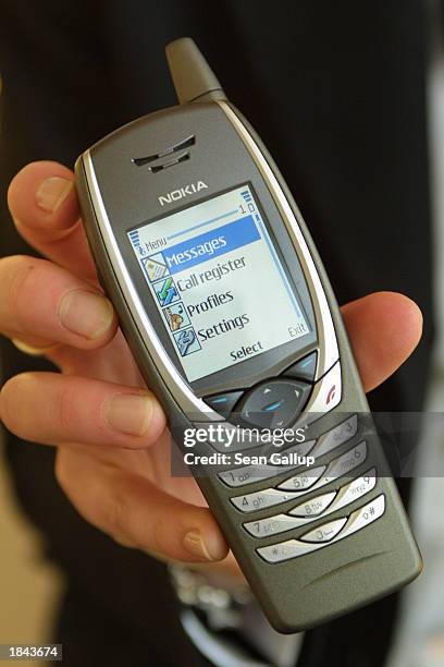 Marketing assistant holds the new Nokia 6650 UMTS capable mobile phone at the CeBIT technology trade fair March 12, 2003 in Hanover, Germany. CeBIT,...