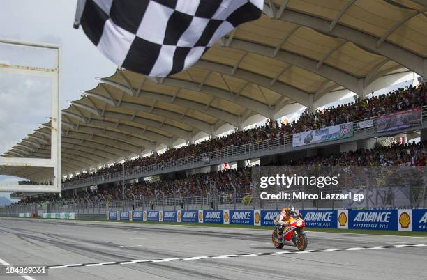 Dani Pedrosa of Spain and Repsol Honda Team crosses the finish line to win the MotoGP Of Malaysia - Race at Sepang Circuit on October 13, 2013 in...