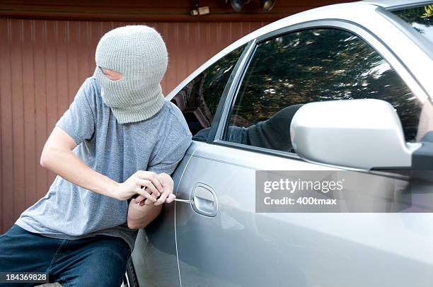grey masked teenager breaking into a car - stolen goods stock pictures, royalty-free photos & images