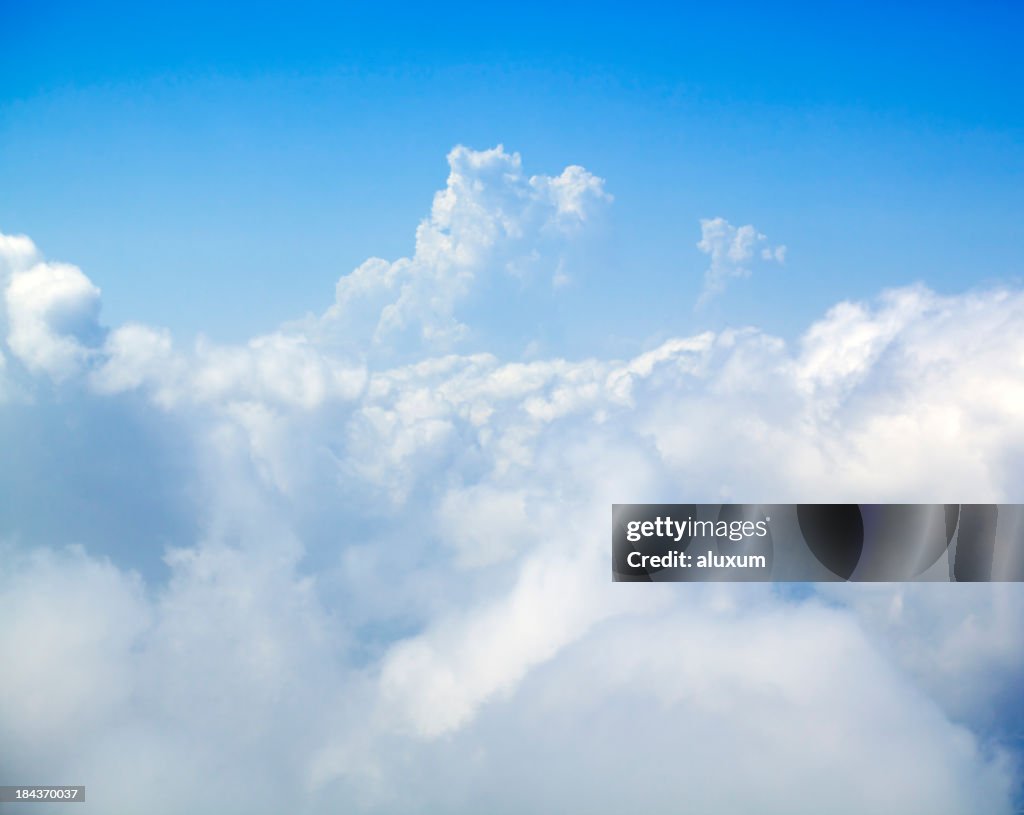 Large white fluffy clouds set against a bright blue sky