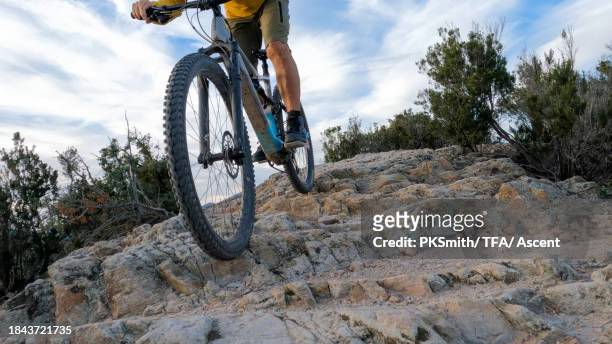 mountain biker rides rock slabs on mountain ridge - fahrrad fahren alte leute beine stock-fotos und bilder