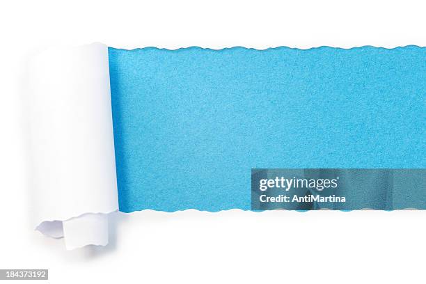 paper torn into roll revealing blue underneath - torn background stock pictures, royalty-free photos & images