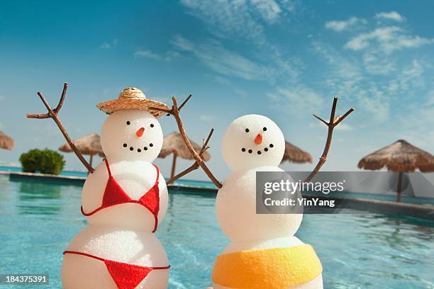 christmas snowman enjoying winter beach vacation fun by swimming pool - mexican christmas stock pictures, royalty-free photos & images