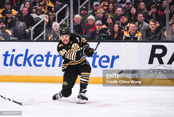 David Pastrnak of the Boston Bruins shoots the puck during the first period against the Arizona Coyotes at TD Garden on December 09, 2023 in Boston,...